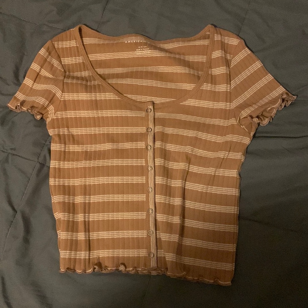 dark yellow baby tee with white stripes and snap buttons